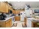 Practical kitchen featuring light oak cabinets, white appliances, and a clean layout at 107 Oakbluff Rd, Summerville, SC 29485