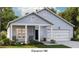 Charming one-story home with light blue siding, a covered porch, and an attached garage at 108 Orchard Blossom Ln, Summerville, SC 29485