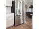 Modern kitchen featuring stainless steel refrigerator and white cabinetry, providing a clean and contemporary aesthetic at 108 Orchard Blossom Ln, Summerville, SC 29485