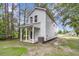 Two-story home featuring a back porch, lush trees, an installed air conditioner, and white siding at 110 Farm Rd # A, Goose Creek, SC 29445