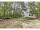 View of the backyard from behind this two-story new construction home surrounded by trees at 110 Farm Rd # A, Goose Creek, SC 29445