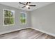 Sun-filled bedroom featuring hardwood-style floors, ceiling fan, and double windows at 110 Farm Rd # A, Goose Creek, SC 29445