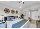 Bright bedroom featuring a queen bed, decorative wall hangings, and a cozy sitting area at 110 Farm Rd # A, Goose Creek, SC 29445