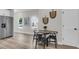 Bright dining area with a round table, wood floors, and a view of the backyard at 110 Farm Rd # A, Goose Creek, SC 29445