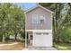 Charming two-story home with gray siding, white trim, attached garage, and a cozy front porch at 110 Farm Rd # A, Goose Creek, SC 29445