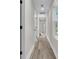 Hallway with white walls, black door hardware, and modern flooring leading to various rooms at 110 Farm Rd # A, Goose Creek, SC 29445