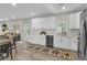 Bright, modern kitchen with white cabinets, stainless steel appliances, and an open view to the living area at 110 Farm Rd # A, Goose Creek, SC 29445