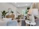 Cozy living room with stylish furniture, plants, and decor, leading to the staircase at 110 Farm Rd # A, Goose Creek, SC 29445