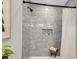 Modern shower with gray tiled walls, built-in niche, and a stylish stool with rolled towels at 110 Farm Rd # A, Goose Creek, SC 29445