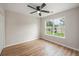 Cozy bedroom features a ceiling fan, wood-look floors, and a window overlooking the backyard at 110 Yorkshire Dr, Summerville, SC 29483