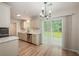 Bright dining area with modern chandelier, white cabinetry, and sliding glass door to patio at 110 Yorkshire Dr, Summerville, SC 29483