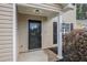 Close-up of front door with house number, black hardware, and tasteful landscaping at 110 Yorkshire Dr, Summerville, SC 29483