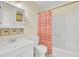 Well-lit bathroom with a white vanity, toilet, and a shower/tub combination with a striped curtain at 1104 Greenmeadow Dr, Goose Creek, SC 29445