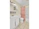 Well-lit bathroom with white fixtures, vanity storage, tile floors and shower tub combo at 1104 Greenmeadow Dr, Goose Creek, SC 29445