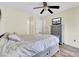 Bedroom featuring wood floors, a ceiling fan, grey dresser, and bed frame with ensuite access to a second bedroom at 1104 Greenmeadow Dr, Goose Creek, SC 29445