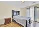 Bright bedroom featuring wood floors, a dark wood bed frame and ensuite access to a private outdoor patio at 1104 Greenmeadow Dr, Goose Creek, SC 29445