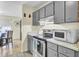 Modern kitchen with stainless appliances, gray cabinets, and a view of the dining area at 1104 Greenmeadow Dr, Goose Creek, SC 29445