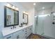 Modern bathroom featuring double sinks, sleek fixtures, and a glass-enclosed shower at 111 Augusta Pass Dr, Ridgeville, SC 29472