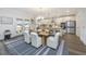 Open dining area features a modern table setting with easy access to the backyard through patio doors at 111 Augusta Pass Dr, Ridgeville, SC 29472