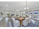 Open-concept dining area with table set, fireplace in living area and view of the kitchen at 111 Augusta Pass Dr, Ridgeville, SC 29472