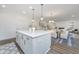 Kitchen with gray island, pendant lighting, and an open concept to dining and living areas at 111 Augusta Pass Dr, Ridgeville, SC 29472