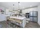 Bright kitchen with white cabinets, stainless appliances, and a large central island with seating at 111 Augusta Pass Dr, Ridgeville, SC 29472
