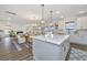 Open concept kitchen with island and seating flows into the dining and living area at 111 Augusta Pass Dr, Ridgeville, SC 29472