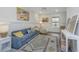 Cozy sitting room with blue sofa, decorative pillows, neutral rug, and natural light at 111 Augusta Pass Dr, Ridgeville, SC 29472