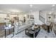 Bright living space with a fireplace, seamlessly connected to the dining and kitchen areas at 111 Augusta Pass Dr, Ridgeville, SC 29472