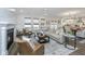 Open-concept living room showcasing stylish furnishings, a fireplace, and seamless flow to the kitchen at 111 Augusta Pass Dr, Ridgeville, SC 29472