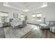 Bright main bedroom with tray ceiling, lots of natural light and a seating area at 111 Augusta Pass Dr, Ridgeville, SC 29472