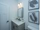 Stylish powder room with modern vanity, mirror, and botanical artwork at 111 Augusta Pass Dr, Ridgeville, SC 29472