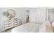 Bright bedroom with a white dresser, gold mirror, and view to the kitchen at 112 Orchard Blossom Ln, Summerville, SC 29485