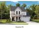 Charming two-story home with white siding, black shutters, and a welcoming front porch at 112 Orchard Blossom Ln, Summerville, SC 29485