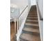 Carpeted staircase with white railing and wood handrail leading to the upper level at 112 Orchard Blossom Ln, Summerville, SC 29485