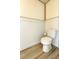 Bathroom featuring a white toilet, wainscotting, and light hardwood floors at 113 Rockdale Ln, Goose Creek, SC 29445
