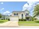 Charming two-story home with a well-manicured lawn and a two-car garage under a blue sky with fluffy white clouds at 113 Rockdale Ln, Goose Creek, SC 29445