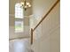Bright foyer with hardwood floors, stairs with white railings, and a large arched window providing natural light at 113 Rockdale Ln, Goose Creek, SC 29445