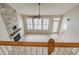 Top of stairs view of living room with fireplace and large windows at 113 Rockdale Ln, Goose Creek, SC 29445