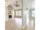 Inviting living room featuring a vaulted ceiling, brick fireplace, hardwood floors, and an open doorway to the kitchen at 113 Rockdale Ln, Goose Creek, SC 29445