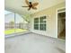Covered patio with ceiling fan provides backyard view and access to the home's interior at 113 Rockdale Ln, Goose Creek, SC 29445
