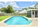 Sparkling blue pool with fenced yard and screened in patio provides backyard fun and safety at 113 Rockdale Ln, Goose Creek, SC 29445