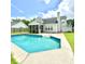 Backyard view of the pool, screen patio, and home with lush green grass and blue skies at 113 Rockdale Ln, Goose Creek, SC 29445