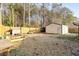 Large backyard with a privacy fence, raised garden beds, shed, and ample space for outdoor activities and landscaping at 113 Surrey Dr, Summerville, SC 29486