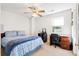 Bright bedroom with blue bedding, a desk, and a ceiling fan at 113 Surrey Dr, Summerville, SC 29486