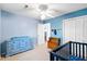 Bedroom showcasing a double door closet, blue dresser with drawers, and a crib with space themed bedding at 113 Surrey Dr, Summerville, SC 29486
