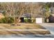 Charming single-story brick home featuring a well-maintained yard and attached garage at 113 Surrey Dr, Summerville, SC 29486