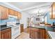 Efficient kitchen with wooden cabinets, tiled floors, and a clear view to the living areas at 113 Surrey Dr, Summerville, SC 29486