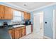 Charming kitchen with wood cabinets, a white dishwasher, and tile backsplash at 113 Surrey Dr, Summerville, SC 29486