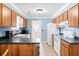 Cozy kitchen featuring wood cabinets, light blue walls, and tile flooring at 113 Surrey Dr, Summerville, SC 29486